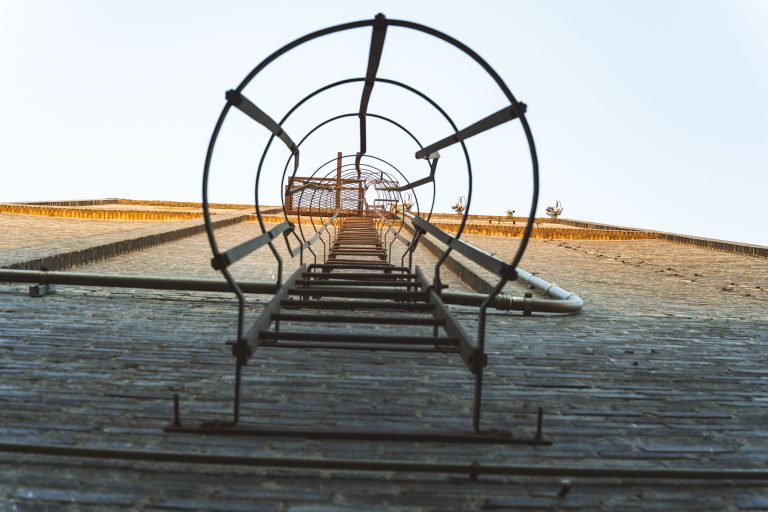 Caged Ladder on Viterra Grain Elevator, Minneapolis 3 Center pivot irrigation system extends across arid agricultural land under clear sky.