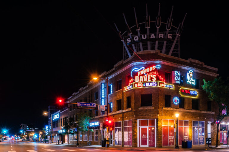 Calhoun Square, Famous Dave's, Hennepin Ave & Lake St, Minneapolis 2 Calhoun Square building at Hennepin Ave & Lake St, Minneapolis, at night, featuring Famous Dave's BBQ & Blues neon sign.