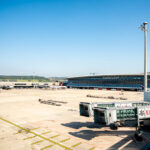 The main terminal complex of Zürich Airport (Flughafen Zürich) sits under a clear blue sky, its modern glass façade reflecting the activity of Switzerland’s busiest air hub. Completed in stages through the early 2000s, the airport serves as the primary gateway for Swiss International Air Lines and one of Europe’s most efficient transfer points. The wide apron and UBS-branded jet bridges foreground the balance between Swiss precision, aviation infrastructure, and corporate presence that defines Zürich’s role in global travel.