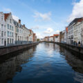 People walking next to the river in Bruges Belgium.