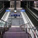 The lower platforms of Berlin Hauptbahnhof, serving tracks 5 and 6, form part of the deep-level north–south route opened with the station in 2006. This subterranean level, approximately 15 meters below ground, connects long-distance ICE services between Hamburg, Leipzig, and Munich through the Tiergarten Tunnel. The design reflects the precision and uniformity of modern German rail architecture—clean concrete forms, stainless steel fixtures, and bright LED signage. The symmetrical layout, glass partitions, and central clock emphasize efficiency and clarity, key elements of the Hauptbahnhof’s function as Europe’s largest crossing-station hub.