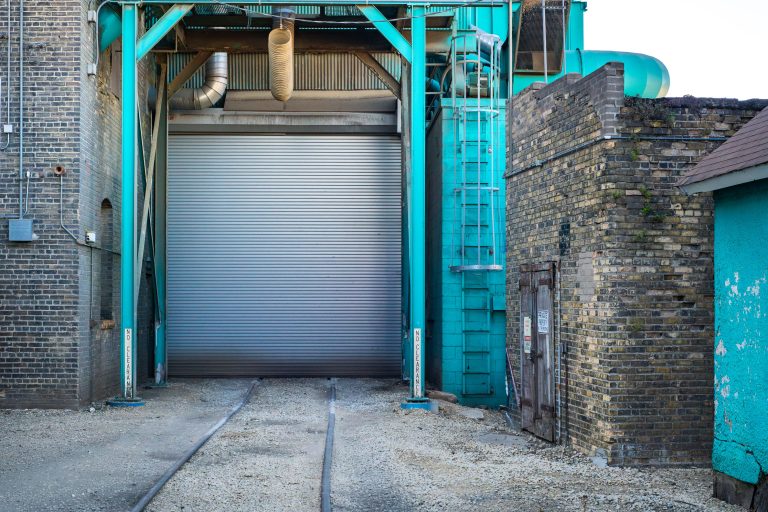 Viterra Grain Elevator Rail Dock, Minneapolis 3 Turquoise steel frame and industrial doors at a Viterra grain elevator facility in Minneapolis.