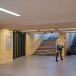 Woman walks to the escalator at theLeopoldplatz U-Bahn Station in Berlin Germany.