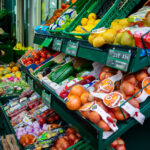 A man shops at a market in Paris, France.