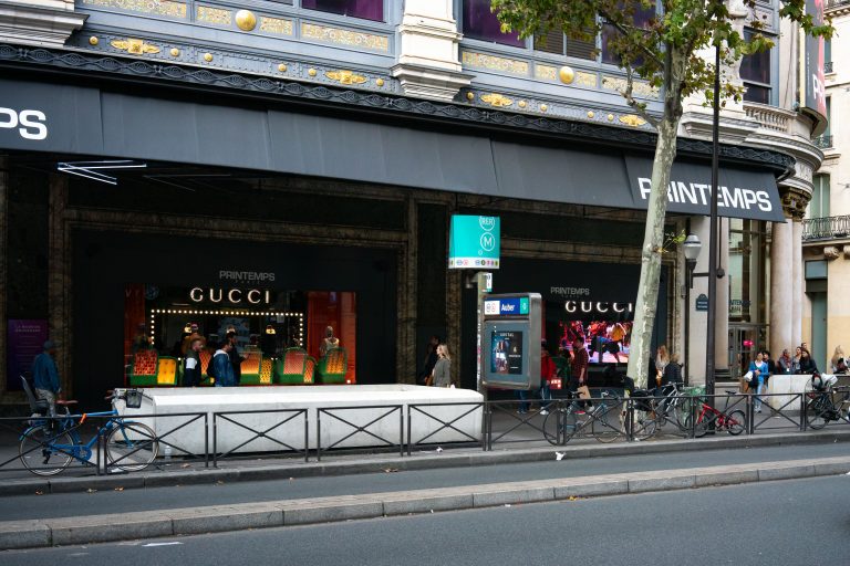 Printemps Department Store, Boulevard Haussmann, Paris 3 Gucci storefront and RER Auber station entrance outside Printemps department store on Boulevard Haussmann, Paris.