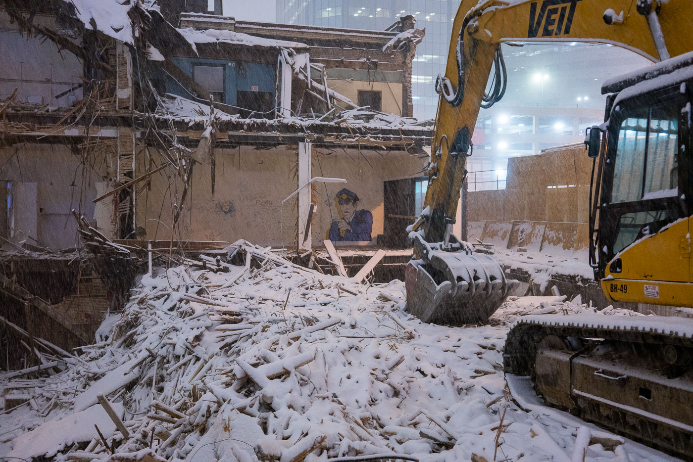 Demolition of violin shop with police graffiti in snow