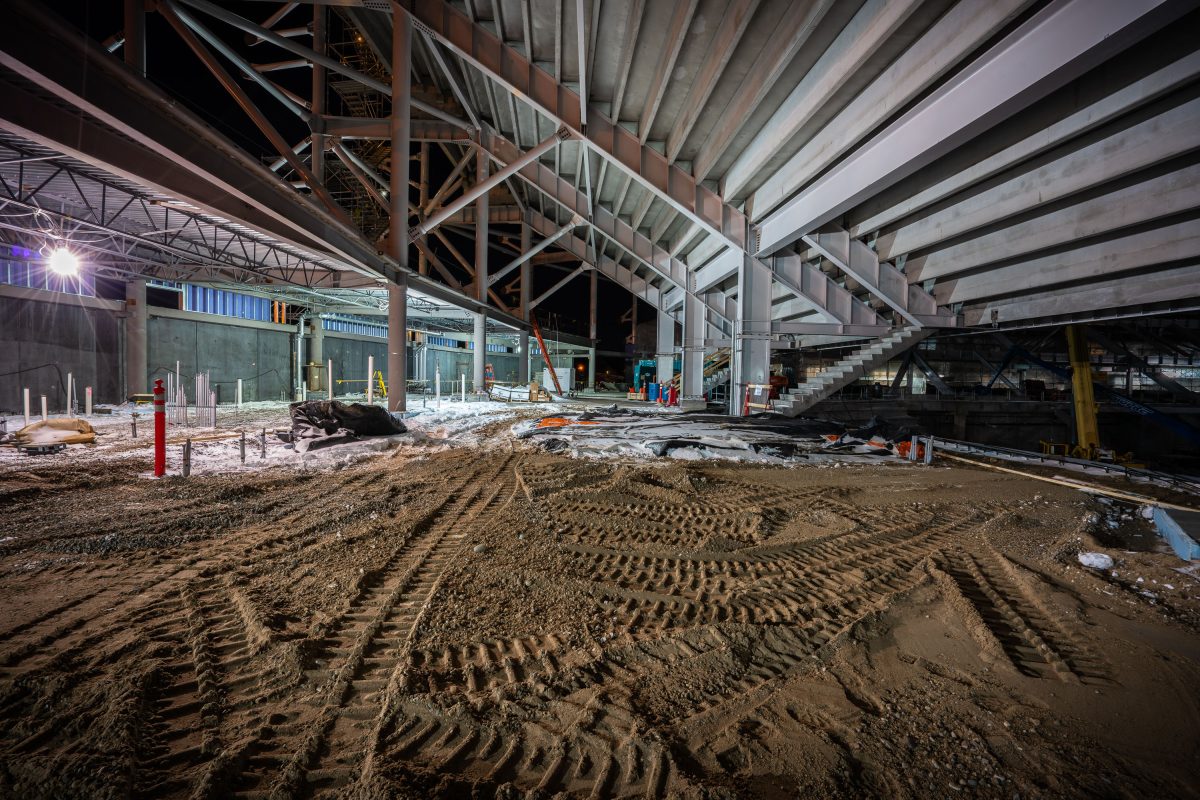 Interior of Allianz Field stadium under construction in St. Paul, Minnesota, showing excavated dirt floor and steel framework.