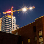 A building gets demolished as a new one rises in the background in Dinkytown, Minneapolis.