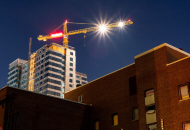 A building gets demolished as a new one rises in the background in Dinkytown, Minneapolis.