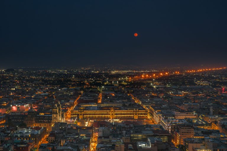 Blood Moon Rising Above Plaza de la Constitución 1 Full moon over the Zócalo and National Palace in downtown Mexico City at night.