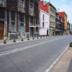 Calle República de Uruguay in Mexico City’s Historic Core 1 Calle República de Uruguay in the heart of Mexico City’s Centro Histórico, lined with colonial-era stone façades and early 20th-century buildings showing layers of renovation and age. The street, paved with basalt cobblestones, reflects the city’s dense architectural history where 18th-century walls coexist with modern storefronts and utilities. The corridor connects the Zócalo area with Eje Central, serving as one of the oldest commercial arteries in the capital.