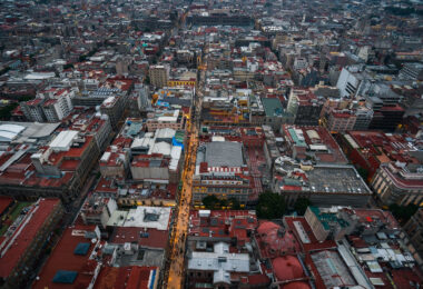 Calle Francisco I. Madero stretches eastward through Mexico City’s Centro Histórico, illuminated as evening falls. This pedestrian artery connects the Torre Latinoamericana to the Zócalo and has been a central commercial corridor since colonial times. Once known as San Francisco Street, its 2010 pedestrianization transformed it into one of the busiest walkways in Latin America, lined with historic facades, retail arcades, and landmarks like the Church of San Francisco and Casa de los Azulejos.