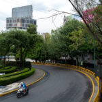 Someone driving a motorcycle around Fuente de los Buhos.