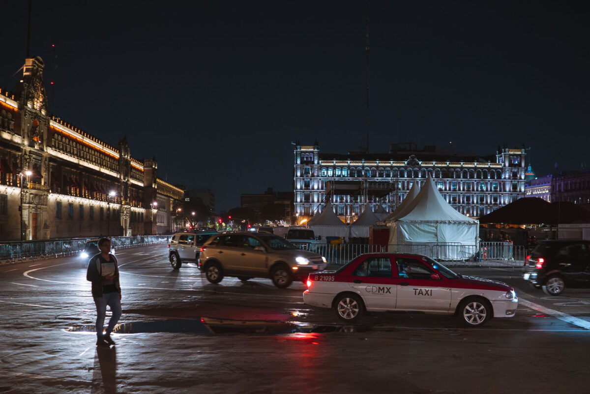 Man walks next to a Taxi in Mexico City Zocalo
