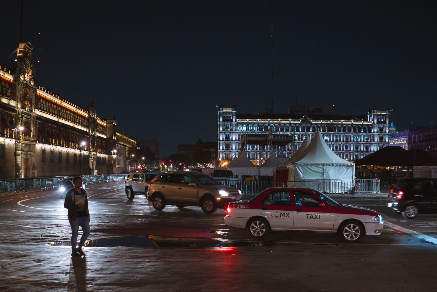 Man walks next to a Taxi in Mexico City Zocalo