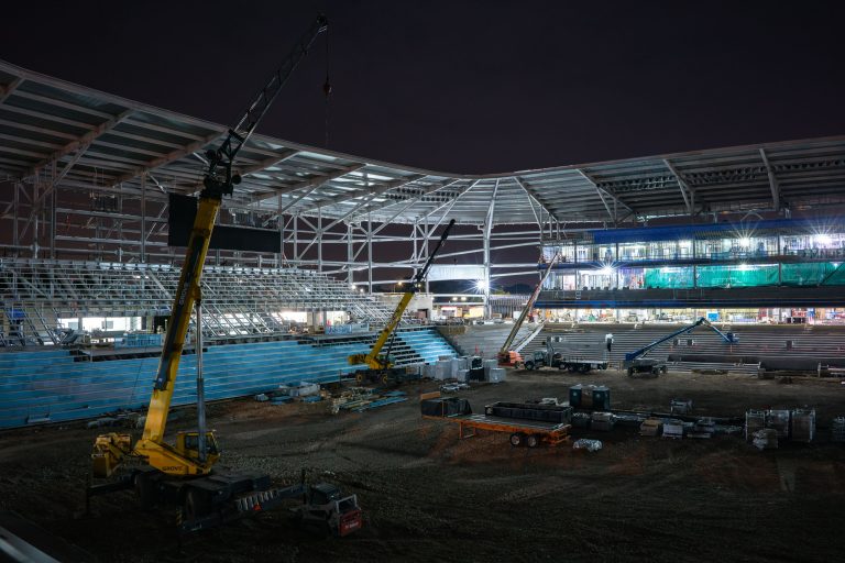 Boom Lifts Working Seating Bowl at Night, Allianz Field, St. Paul 1 Yellow mobile crane operates inside Allianz Field stadium under construction at night in St. Paul.