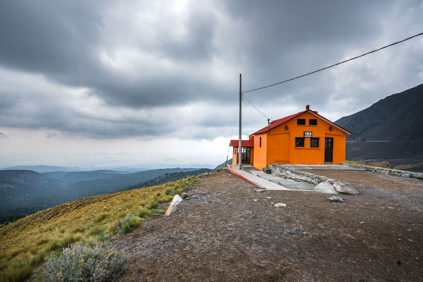 Orange mountain refuge building on Nevado de Toluca, Mexico, a stratovolcano west of Mexico City known for its crater lakes and alpine flora.