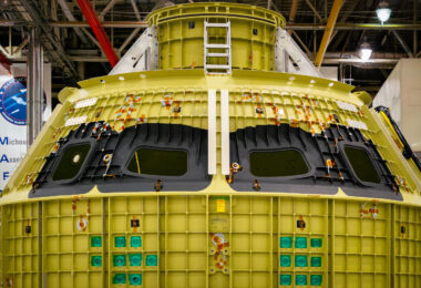 The Orion crew module is seen in mid-assembly at NASA’s Michoud Assembly Facility in New Orleans. Built by Lockheed Martin, the pressure vessel forms the core structure of the spacecraft that will carry astronauts on Artemis missions to the Moon and beyond. The aluminum-lithium frame is precision-welded to withstand the stresses of launch and deep-space travel, while the black sections mark window openings for crew visibility during flight. Each unit is assembled and tested at Michoud before being shipped to the Kennedy Space Center for integration with the European Service Module and the Space Launch System rocket.