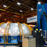 Boeing Dome Section on I-STIR Welder – NASA Michoud 4 At NASA’s Michoud Assembly Facility in New Orleans, Boeing engineers use a PAR Systems I-STIR Friction-Stir Welder to join massive aluminum dome sections for next-generation aerospace vehicles. The process forges metal under intense pressure and heat without melting it, producing welds with exceptional structural integrity for components such as rocket fuel tanks and spacecraft pressure vessels. The Michoud facility, once home to Saturn V and Space Shuttle tank production, continues its role as one of the nation’s key centers for large-scale precision manufacturing and spaceflight hardware assembly.