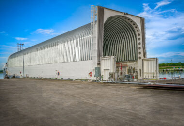 The NASA transport barge Pegasus is shown moored at the Michoud Assembly Facility in New Orleans, Louisiana. Designed to carry the massive core stages of the Space Launch System (SLS), Pegasus features a climate-controlled cargo hold and a retractable bow door to accommodate the rocket’s 212-foot-long components. Originally used to move Space Shuttle external tanks, the vessel was extensively refitted and lengthened in 2014 to support NASA’s Artemis program. It remains a key link between NASA’s Gulf Coast manufacturing site and the Kennedy Space Center in Florida.