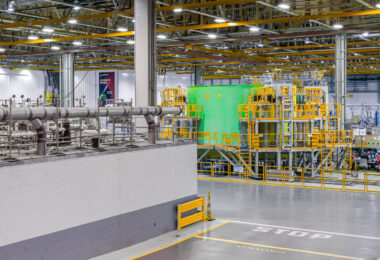 Inside the cavernous NASA Michoud Assembly Facility in New Orleans, the green-painted structure of a Space Launch System (SLS) rocket component dominates the factory floor. Surrounded by yellow access platforms and intricate piping, this section is part of the massive tooling infrastructure used to assemble and test rocket core stages. Overhead cranes and precision systems support Boeing’s production of “America’s Rocket,” with each stage destined for integration into NASA’s Artemis program to return humans to the Moon.