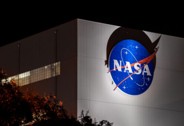 The NASA logo illuminated on the side of the Michoud Assembly Facility in New Orleans, Louisiana. Established during World War II and later repurposed for the Apollo and Space Shuttle programs, the vast complex continues to play a central role in U.S. space manufacturing. Today, Michoud supports construction of major components for NASA’s Artemis missions, including the Space Launch System rocket and Orion spacecraft.