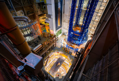 Inside NASA’s historic Vehicle Assembly Building (VAB) at Kennedy Space Center, towering steel gantries and massive cranes dominate the cavernous interior. This is one of the largest single-story buildings in the world, designed in the 1960s to stack the Saturn V rockets of the Apollo program and now used for assembling the Space Launch System (SLS) for the Artemis missions. The central high-bay area, seen here from above, includes multiple platforms and access decks allowing engineers to integrate and inspect rocket stages with millimeter precision. The structure’s immense scale—capable of accommodating vehicles over 500 feet tall—remains a defining symbol of America’s spaceflight engineering capability.