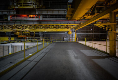 An elevated view of the overhead gantry crane system inside NASA’s Michoud Assembly Facility in New Orleans. These yellow steel cranes are used to lift and maneuver rocket sections, including the massive Space Launch System core stages, within the cavernous production hall. The network of platforms, rails, and suspended hooks demonstrates the industrial scale of spacecraft manufacturing that has taken place here since the Apollo and Space Shuttle programs.