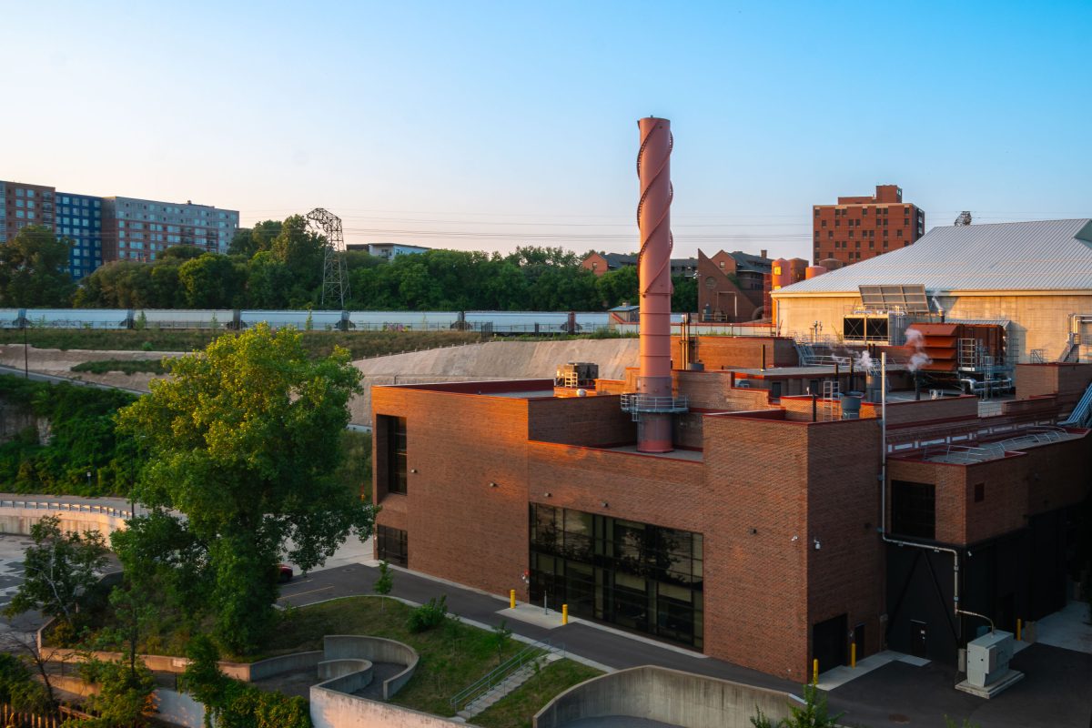 Brick steam plant with a tall spiral-patterned smokestack near the University of Minnesota campus in Minneapolis.