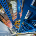 Vertical Assembly Tower at NASA’s Michoud Facility 2 A view from the upper levels of the Vertical Assembly Center at NASA’s Michoud Assembly Facility in New Orleans. The massive blue structure supports the assembly and welding of the Space Launch System’s core stage, the primary rocket used for Artemis missions. This 170-foot-tall tool precisely aligns and joins large rocket sections, a key part of NASA’s ongoing production of deep space launch vehicles.