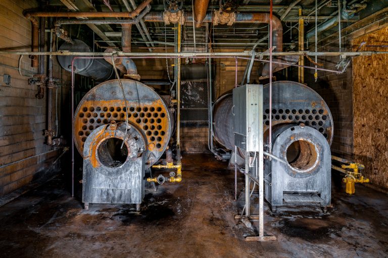 Twin Fire-Tube Boilers, Abandoned Cold Storage Plant, Minnesota 2 Two industrial boilers with perforated steel drums in an abandoned cold storage facility.