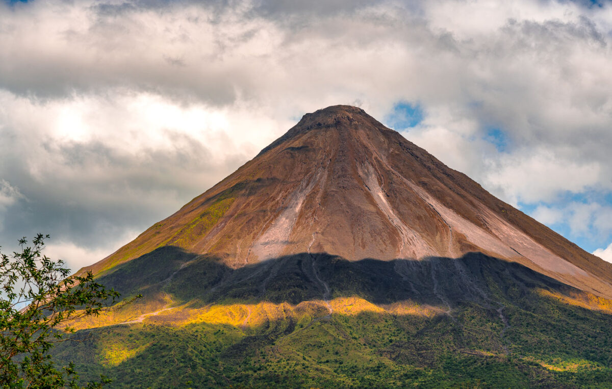 Arenal Volcano in Costa Rica with shadows from the clouds.
