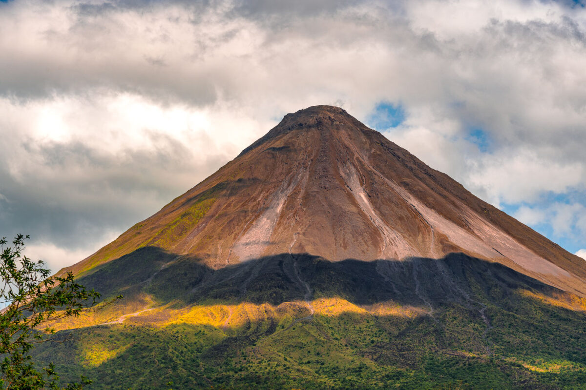 Arenal Volcano in Costa Rica with shadows from the clouds.