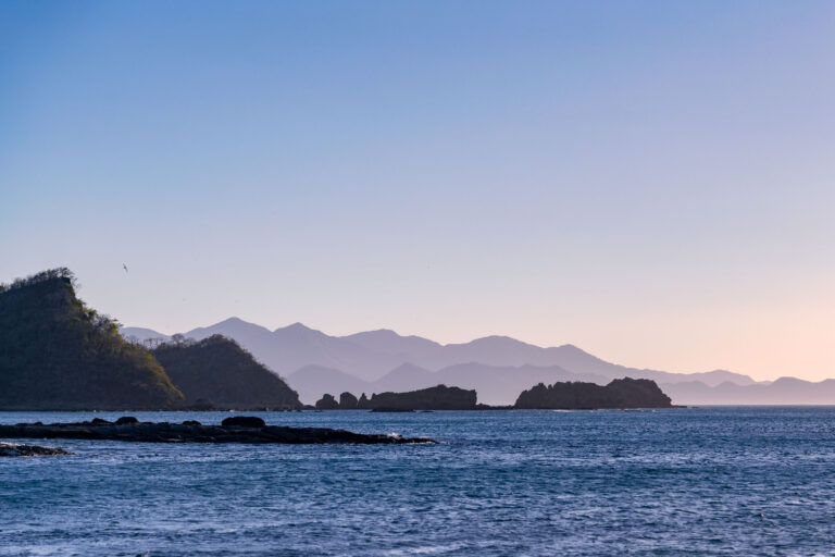 Jobo Bay Coastline, Guanacaste, Costa Rica 4 Rugged coastline with rocky outcrops at Jobo Bay, Guanacaste, Costa Rica, with layered mountains in the distance.