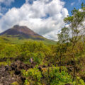 A woman hiking on the lava trails below the Arenal Volcano in Costa Rica.