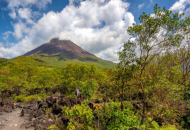 A woman hiking on the lava trails below the Arenal Volcano in Costa Rica.