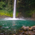 A woman swimming at the base of the La Fortuna Waterfall in Costa Rica.