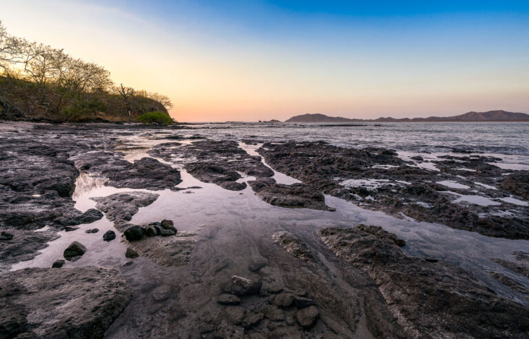 Tamarindo Beach Tide Pools, Costa Rica 4 Rocky tide pools at Tamarindo Beach, Costa Rica, during low tide, revealing the marine ecosystem along the Pacific coast at dawn or dusk.