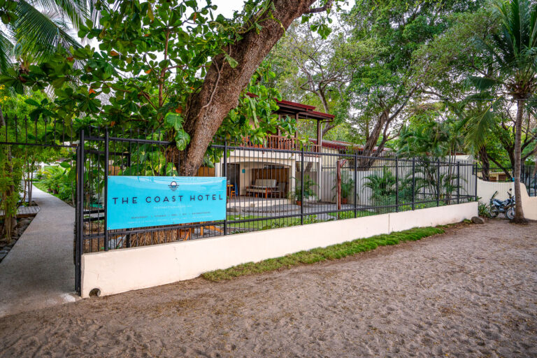 The Coast Hotel, Tamarindo, Costa Rica 2 The Coast Hotel sign on a black metal fence in Tamarindo, Costa Rica, a beach town known for surfing and tourism.