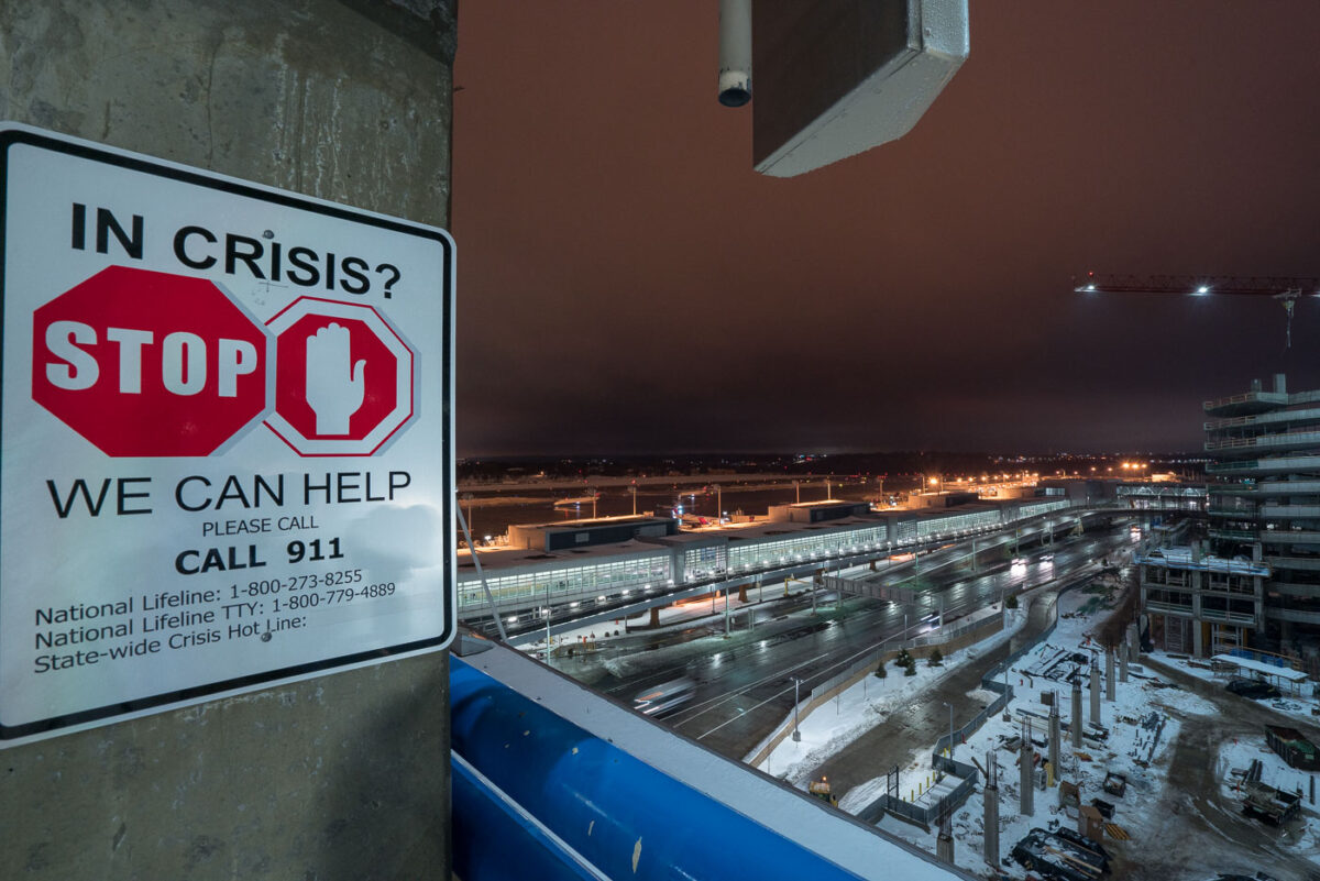 A "In Crisis?" sign on the top floor of the parking ramp at the Minneapolis St. Paul Airport (MSP) in Bloomington.