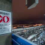 A "In Crisis?" sign on the top floor of the parking ramp at the Minneapolis St. Paul Airport (MSP) in Bloomington.