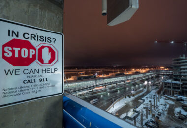 A "In Crisis?" sign on the top floor of the parking ramp at the Minneapolis St. Paul Airport (MSP) in Bloomington.