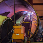 Man working on a water tank for the Hennepin Energy Recovery Center.
