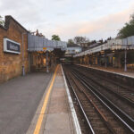 Blackheath railway station, a historic stop on the Southeastern line in southeast London, dates to the mid-19th century and still retains much of its Victorian charm. Its cast-iron canopies, decorative awnings, and brickwork walls reflect the architectural style of early suburban railway expansion. The platforms here serve frequent trains between London Charing Cross, Cannon Street, and Kent, making it a busy commuter link by day. In the quiet of dusk, however, the station takes on a tranquil character — a rare pause in the constant rhythm of London’s rail network.