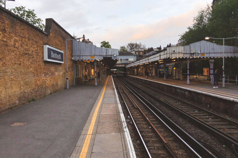 Evening Commuter Calm at Blackheath Station 1 Blackheath railway station, a historic stop on the Southeastern line in southeast London, dates to the mid-19th century and still retains much of its Victorian charm. Its cast-iron canopies, decorative awnings, and brickwork walls reflect the architectural style of early suburban railway expansion. The platforms here serve frequent trains between London Charing Cross, Cannon Street, and Kent, making it a busy commuter link by day. In the quiet of dusk, however, the station takes on a tranquil character — a rare pause in the constant rhythm of London’s rail network.