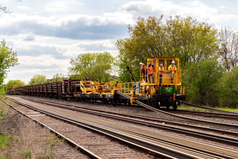 Rail Loader Crew Works on the Southwest LRT Line in St. Louis Park 3 Workers install new rail tracks for the Metro Transit Green Line Extension in St. Louis Park.