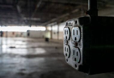 An electrical outlet inside an empty warehouse.