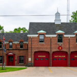 Green Bay Fire Station No. 3, located in Green Bay, Wisconsin, represents a classic mid-20th-century firehouse design with its red brick façade, steep rooflines, and distinctive arched bay doors. Serving the west side of the city, this station houses an engine company, battalion chief, and medic unit, providing rapid response coverage to nearby residential and commercial areas. The building’s architecture reflects an era when civic structures balanced functionality with traditional craftsmanship, embodying a sense of permanence and community trust.