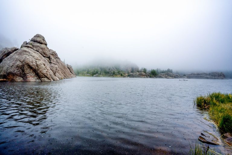 Fog Over Sylvan Lake, Custer State Park, South Dakota 1 Granite boulders frame Sylvan Lake in South Dakota's Custer State Park under overcast skies.