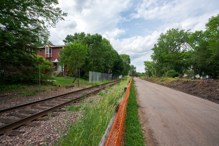 Safety Fencing Along the Kenilworth Trail Rail Corridor 2 Orange safety fencing installed along Kenilworth Trail during Metro Green Line Extension construction in Minneapolis.